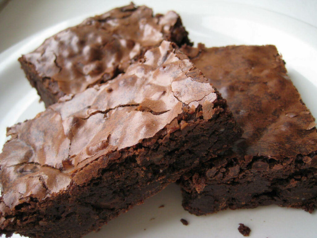 High-resolution brownies with shiny chocolate crust wallpaper showcasing rich dessert textures