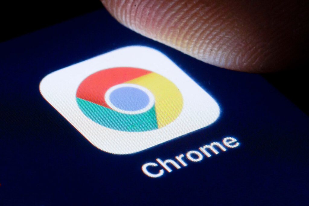 Close-up of Google Chrome icon bright colors on dark background showcasing web browser app Wallpaper