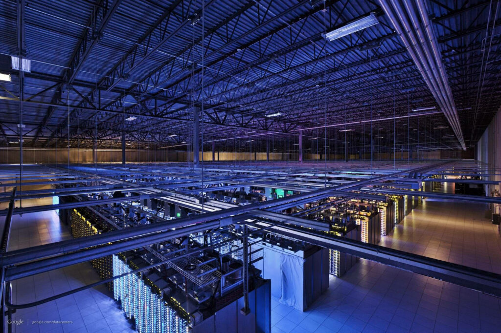 Google Data Center interior with rows of illuminated servers blue purple lights modern technology Wallpaper