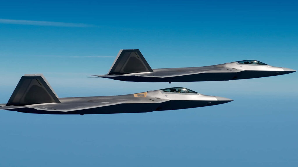 Fierce and Fast: Majestic F-22 Raptor Jumbo Jets Soar Through the Azure Skies Wallpaper