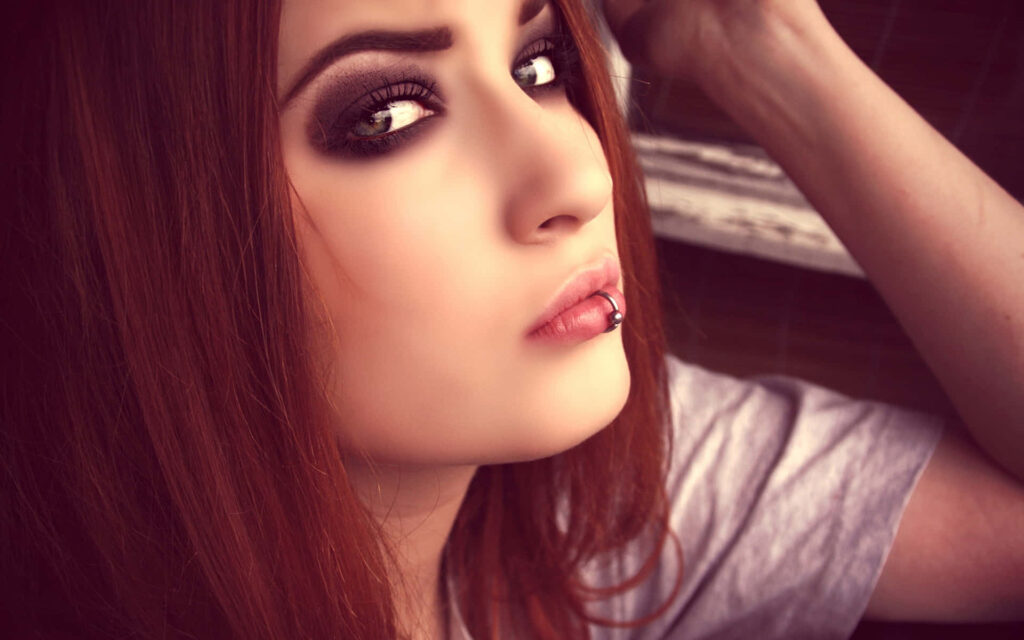 Emo Chic: A Stunning Profile Wallpaper of a Stylish Girl with Long Red Hair and Bold Makeup