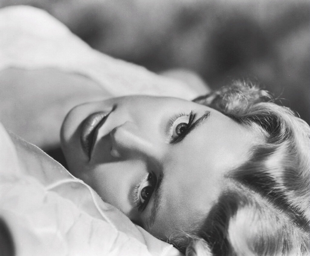 Grace Kelly fierce intense portrait lying down elegant bold captivating wallpaper background