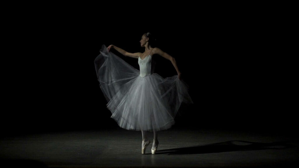 Graceful Asian Ballerina Dazzles in Enchanting Ballet Pose Against a Stunning Dance Pose Backdrop Wallpaper
