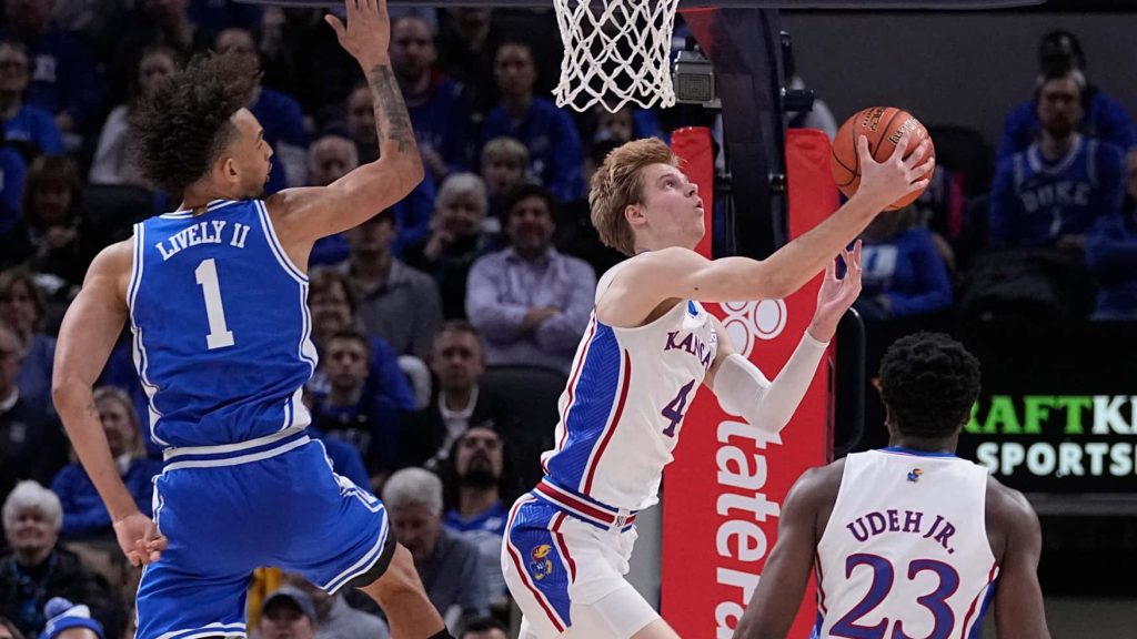Gradey Dick driving for a shot vs Dereck Lively II intense Kansas Jayhawks Duke basketball game Wallpaper