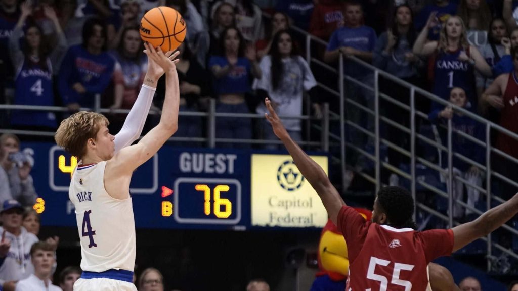 Gradey Dick basketball jump shot over defender Kansas Jayhawks vibrant game action wallpaper