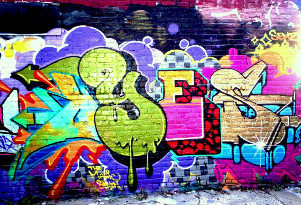 Abstract Expressions: Vibrant Graffiti Unleashed on the Wall - HD Wallpaper Background