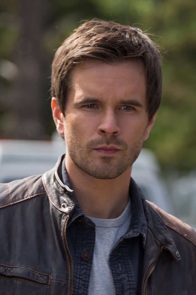 Close-up portrait of actor Graham Wardle in dark brown leather jacket outdoor background Wallpaper