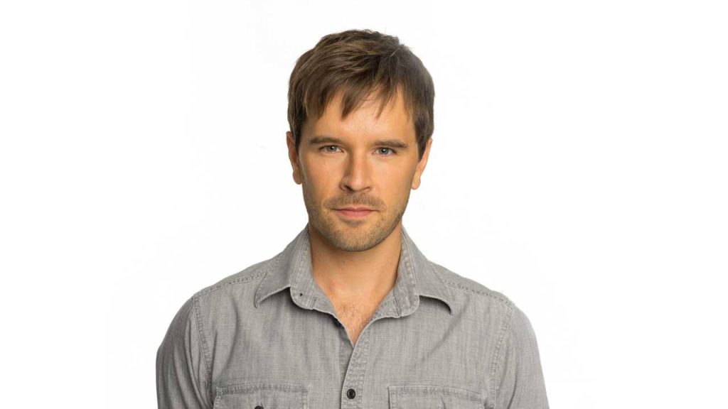 Portrait of actor Graham Wardle from Heartland in casual grey shirt on white background Wallpaper