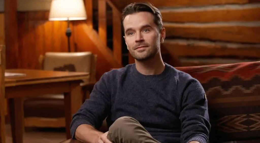 Portrait of Canadian actor Graham Wardle in navy sweater in warm rustic cabin lighting Wallpaper
