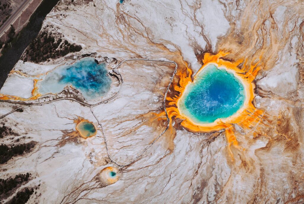 Aerial view of Grand Prismatic Spring Wyoming vibrant blue center orange yellow mineral bands wallpaper