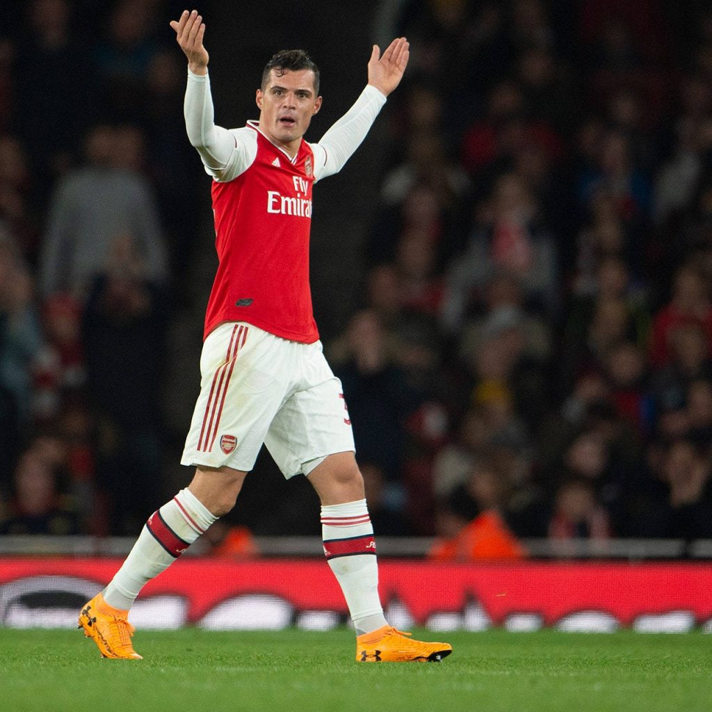 Granit Xhaka Arsenal midfielder celebrating intense moment bright stadium lighting wallpaper
