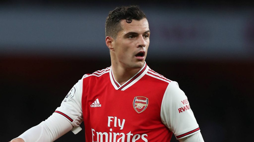 Granit Xhaka focused Arsenal jersey intense football action stadium lighting wallpaper background