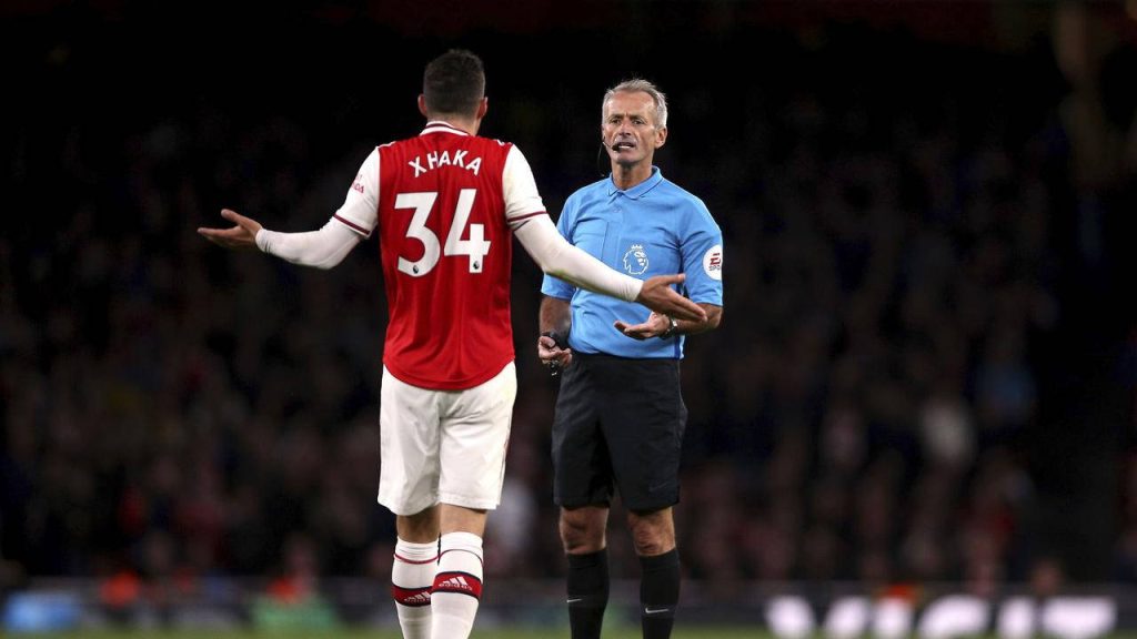 Arsenal midfielder Granit Xhaka arguing with Premier League referee intense football moment Wallpaper