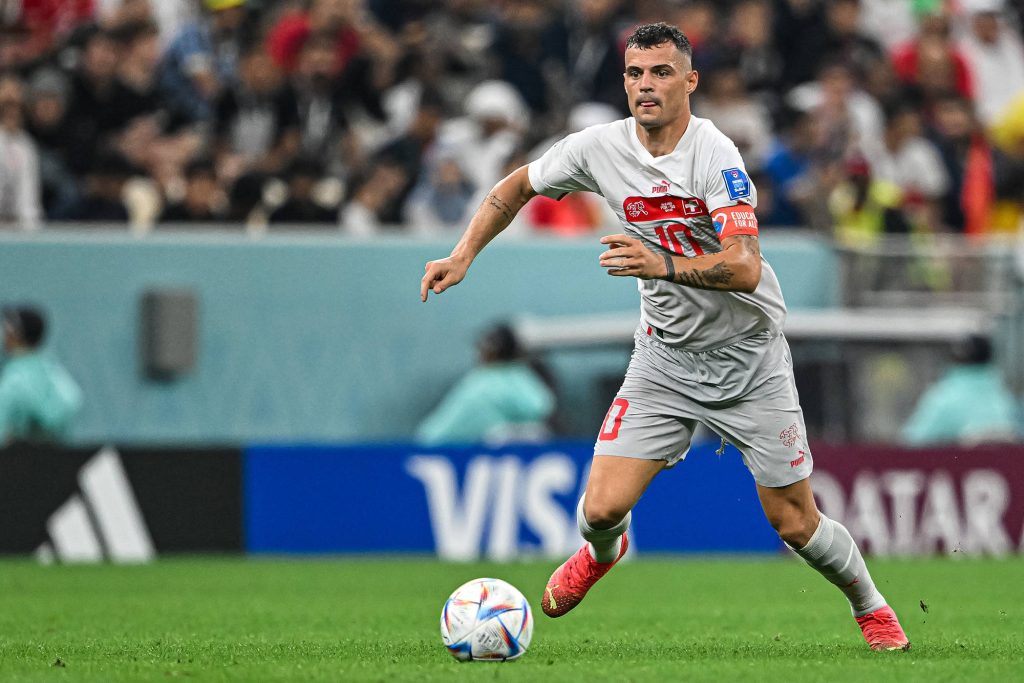 Granit Xhaka Swiss midfielder dribbling ball in national team kit intense football action wallpaper