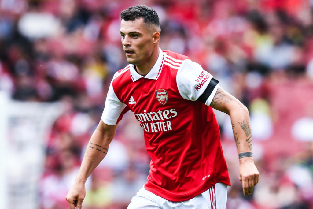 Granit Xhaka Action Wallpaper: Focused Arsenal Jersey Background