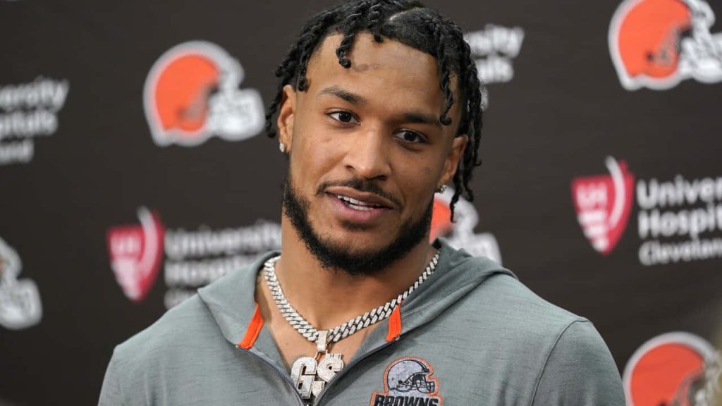 Cleveland Browns safety Grant Delpit at press conference in gray hoodie with team backdrop Wallpaper