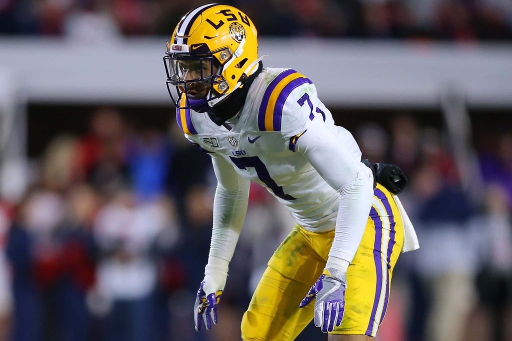 Grant Delpit LSU football wallpaper in purple and gold number 7 focused tackling stance