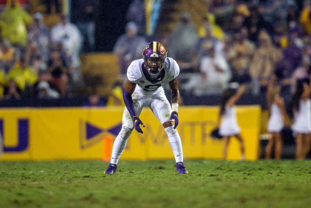 Grant Delpit LSU football player in white purple uniform intense night game action wallpaper