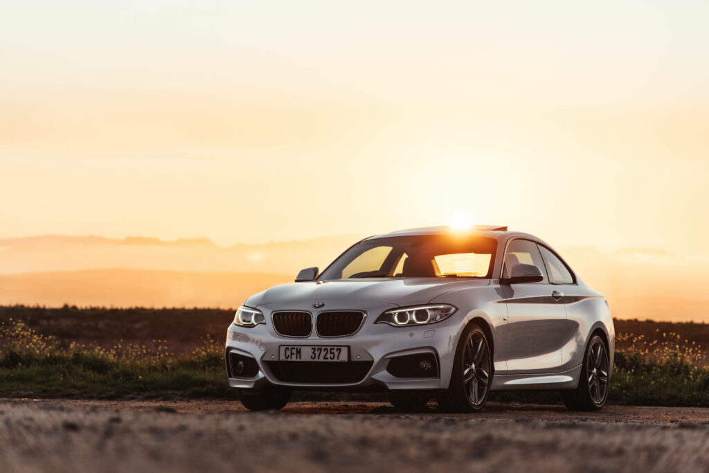 Dawn Drive: Stunning Shot of a Sleek Gray BMW M5 Series Embracing the Sunrise Wallpaper