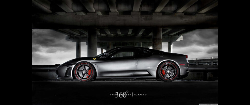 Exquisite Gray Ferrari Speeding Through a Majestic Grayscale Landscape Wallpaper
