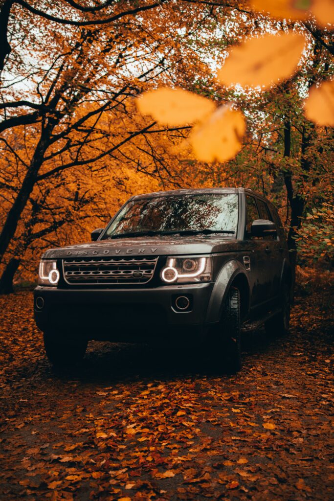 Gray Land Rover Discovery SUV Amidst Vibrant Autumn Foliage Wallpaper