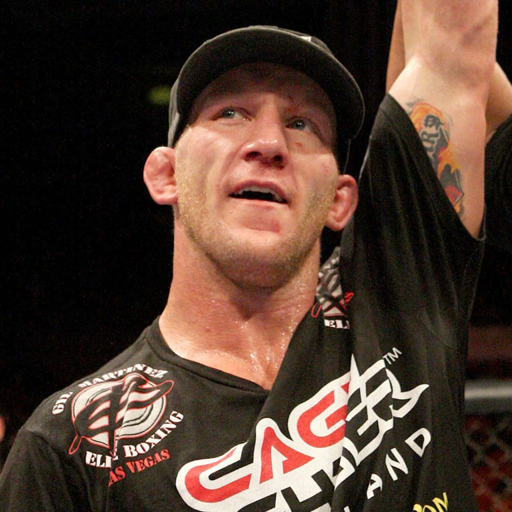MMA fighter Gray Maynard celebrating with focused expression in black Cage Fighter shirt wallpaper