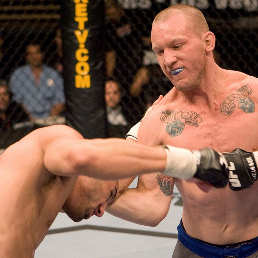 Gray Maynard MMA UFC fight action mid-strike Octagon intense sports photography wallpaper
