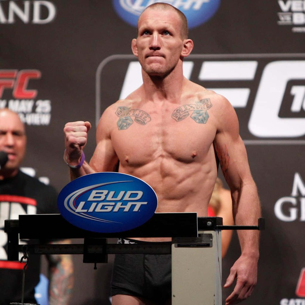 UFC fighter Gray Maynard shirtless with chest tattoos fist raised on Bud Light scale intense MMA weigh-in Wallpaper