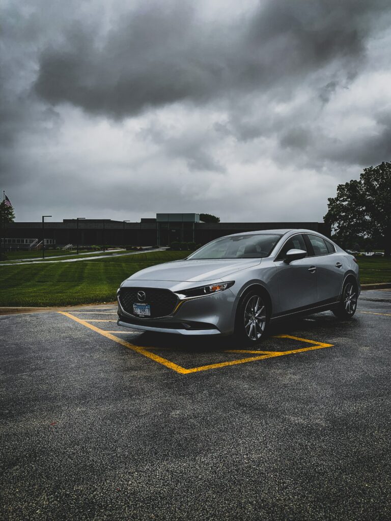 Gray Mazda Car Side View: Moody Rainy Day Wallpaper