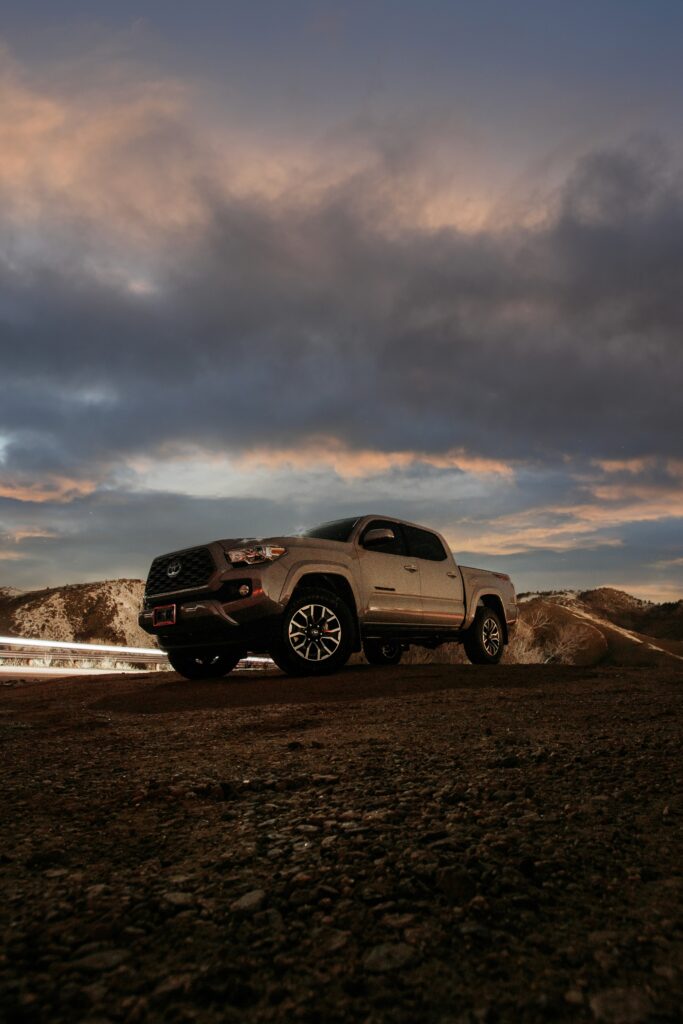 Gray Toyota Pickup Truck on Rugged Road: Dramatic Sky Wallpaper