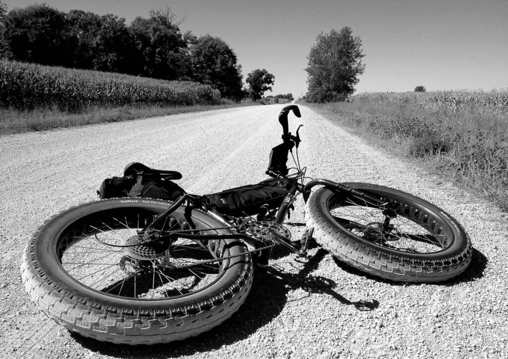 Grayscale Bike on Gravel Road: Capturing Rural Simplicity Wallpaper