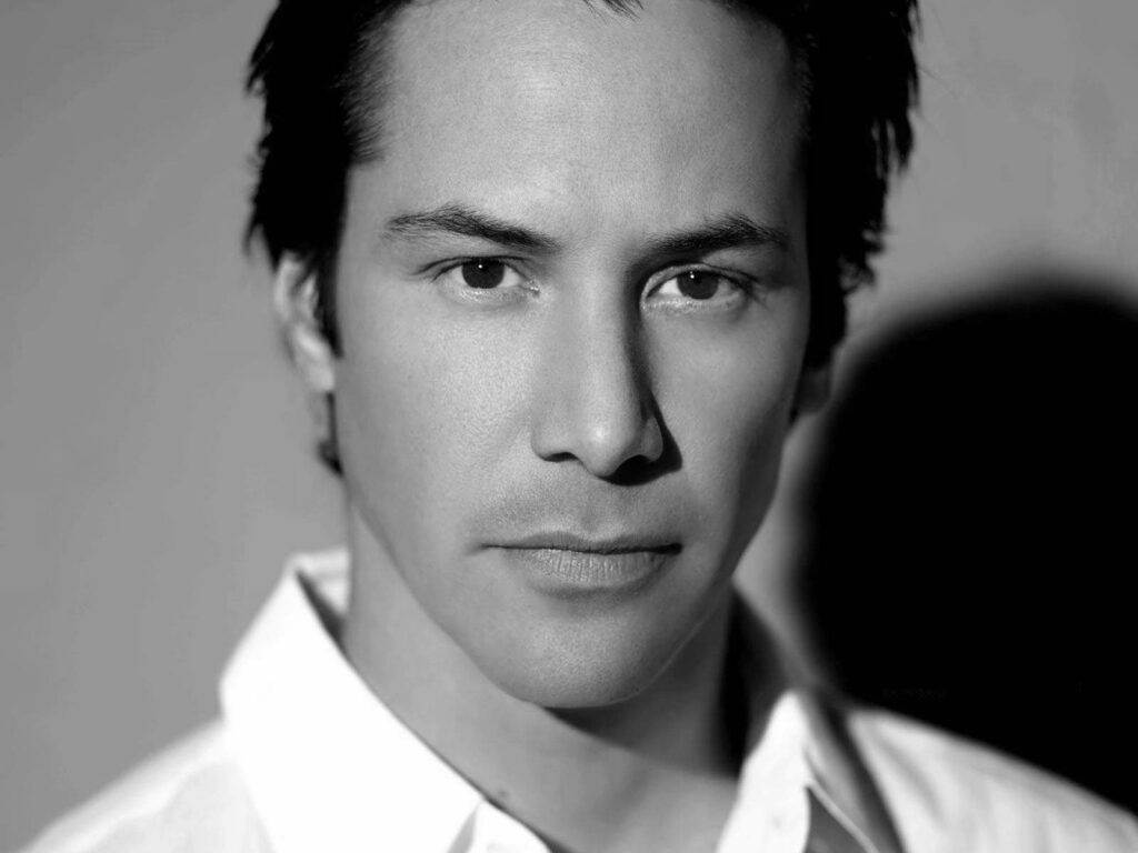 Grayscale Keanu Reeves Portrait: Intense Expression Wallpaper Background