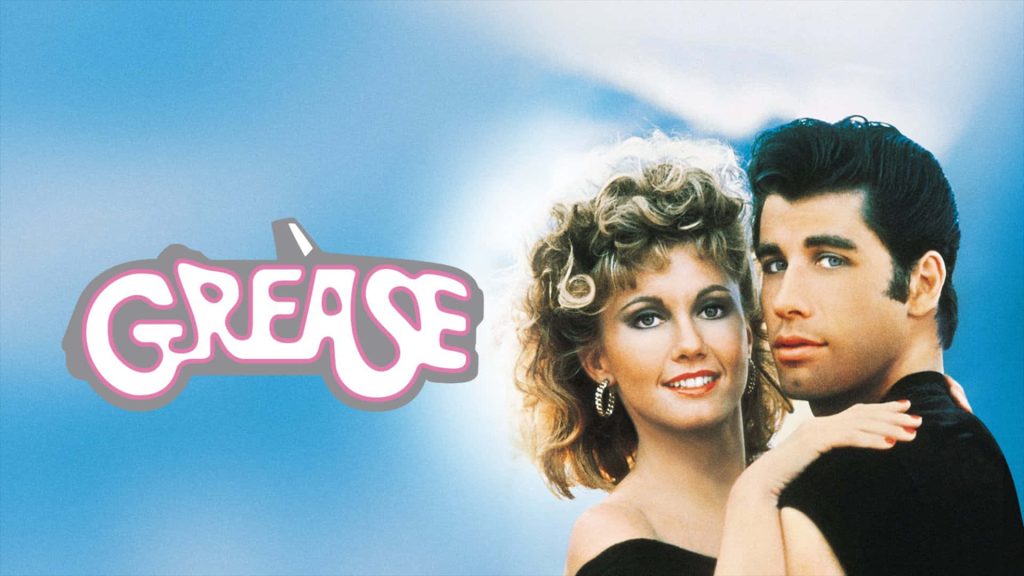 Grease 1978 wallpaper with John Travolta Olivia Newton-John Danny Sandy blue background logo