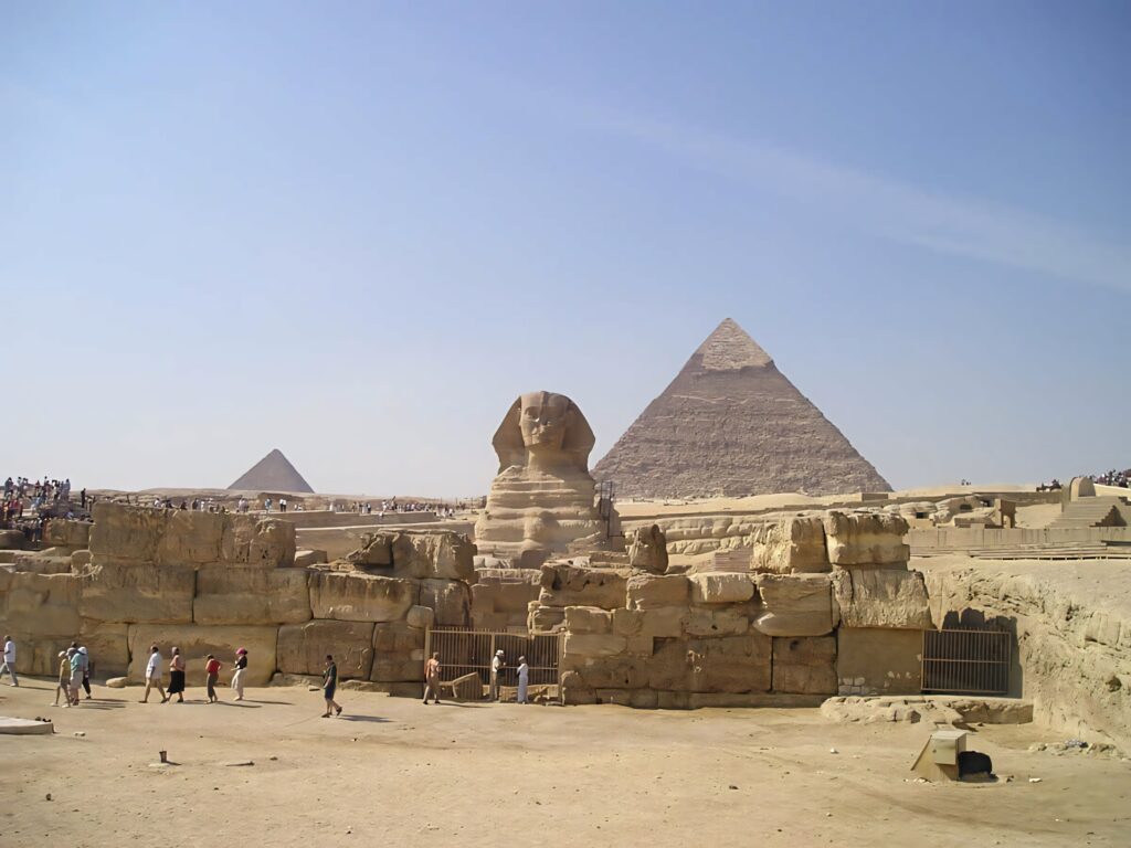 Great Sphinx of Giza with pyramids and clear blue sky desert landscape wallpaper background