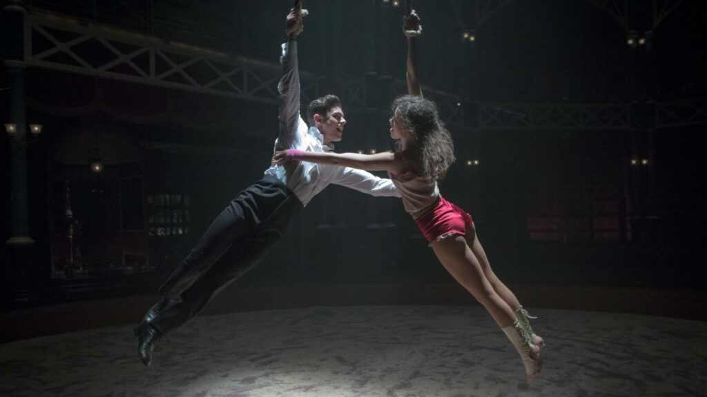 Aerial circus performance from The Greatest Showman wallpaper showcasing dynamic energy and artistry