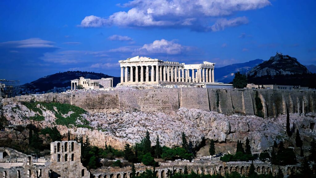 Greek Acropolis with Parthenon on rocky hill under clear blue sky historic Athens wallpaper background