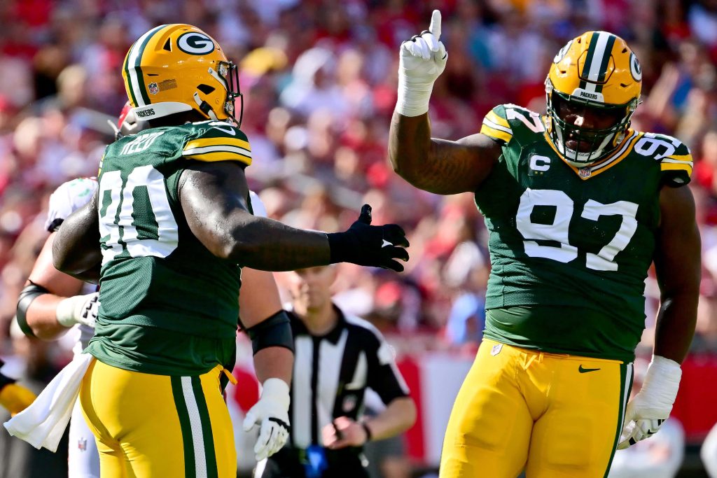 Green Bay Packers Kenny Clark and Jarran Reed celebrate in action at Raymond James Stadium game Wallpaper