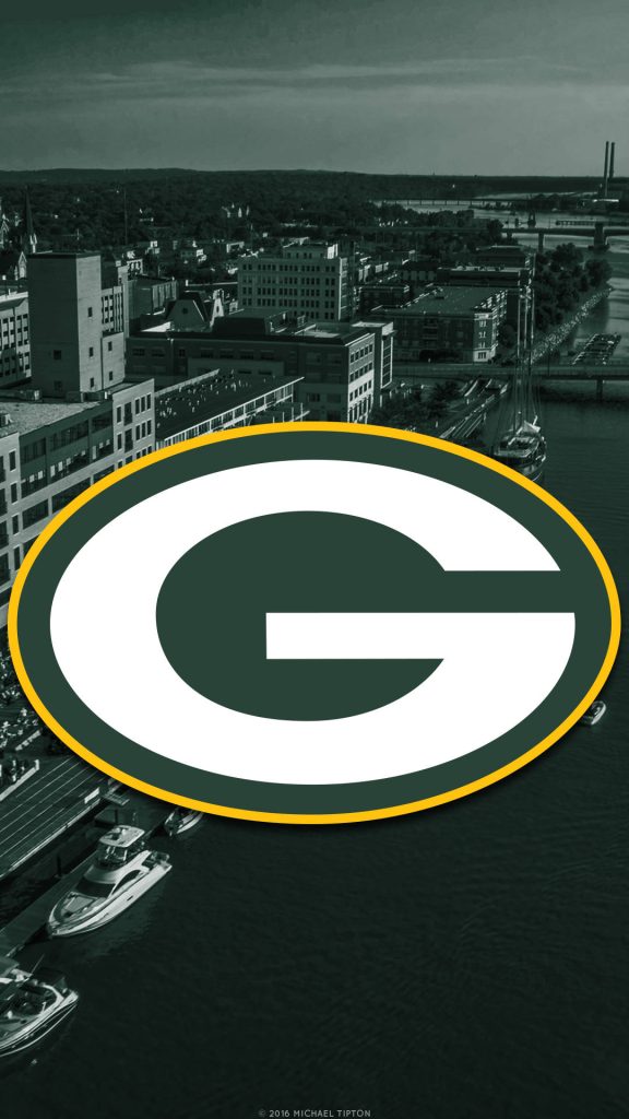 Green Bay Packers G logo over aerial Green Bay waterfront cityscape wallpaper background
