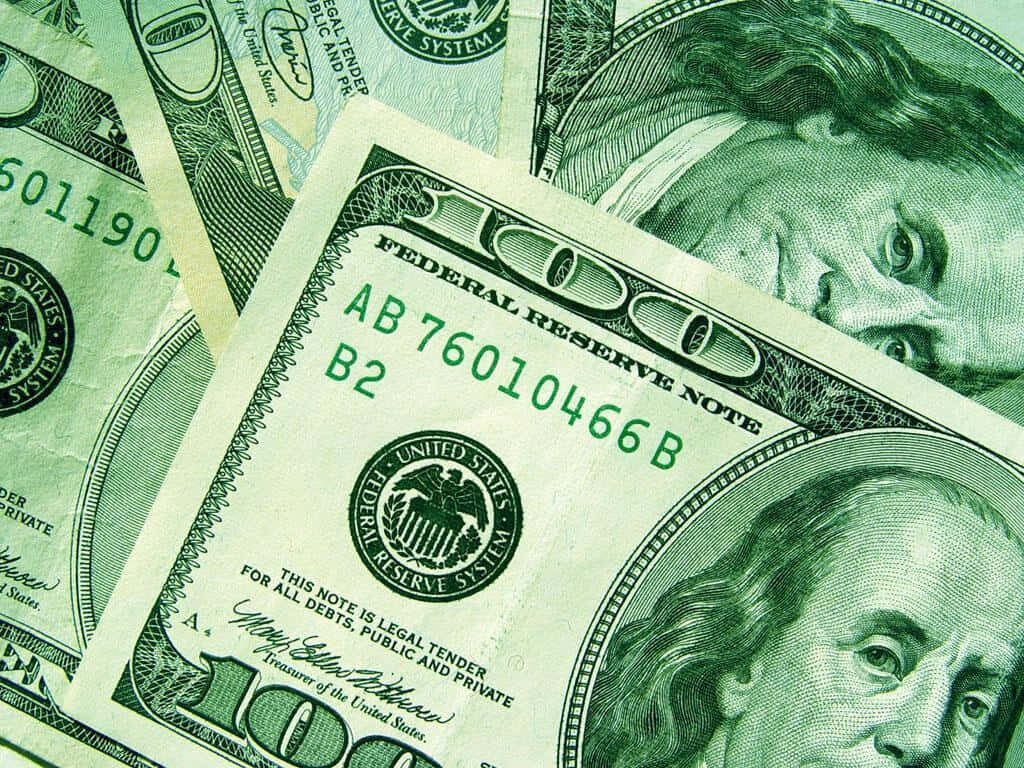 Green Wealth: A Photographic Masterpiece of Hundred Dollar Bill Notes as a Striking Desktop Background Wallpaper