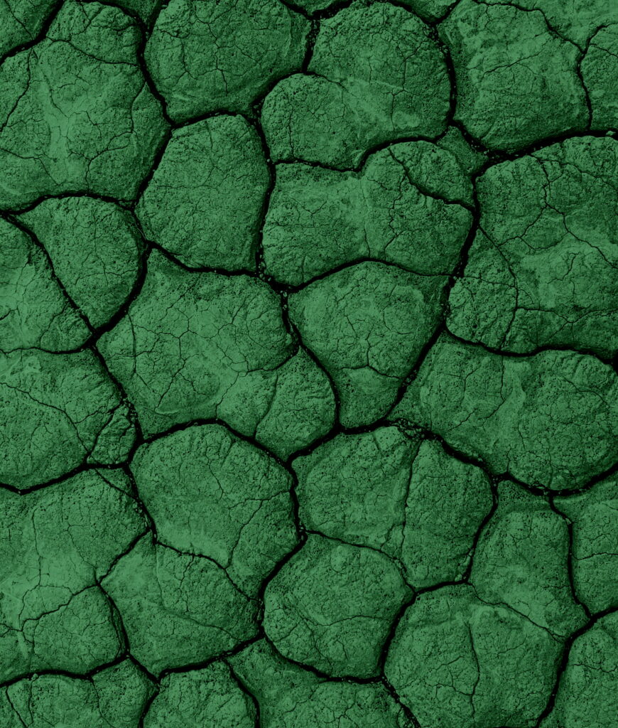 Close-up of cracked earth in deep emerald and forest green tones textured abstract wallpaper