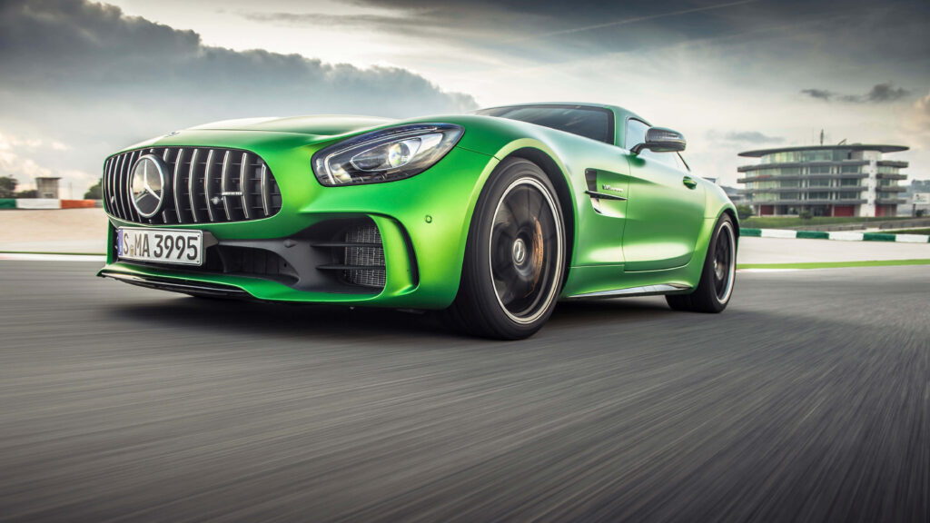 Green Mercedes AMG GT R racing on track high performance sleek design dynamic motion wallpaper