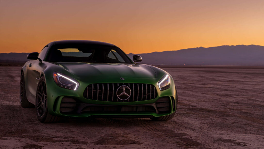 Green Mercedes Benz AMG GT R sports car under vibrant sunset sky showcasing bold design Wallpaper