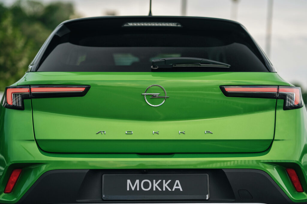 Rear view of green Opel Mokka car minimalist wallpaper perfect for automotive enthusiasts background