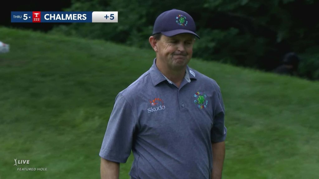 Professional golfer Greg Chalmers focused on course wearing gray polo and navy cap green background Wallpaper