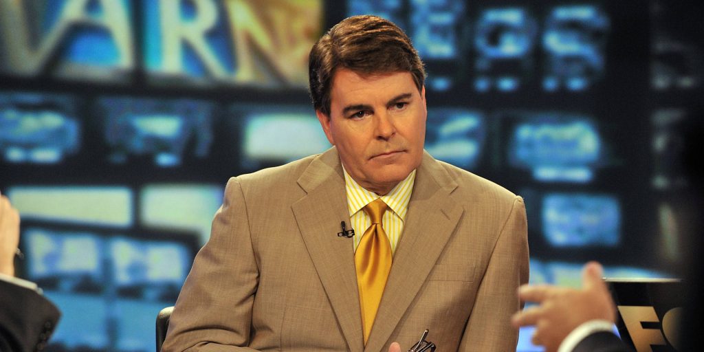 Gregg Jarrett Fox News analyst in tan suit yellow tie in studio digital newsroom background wallpaper