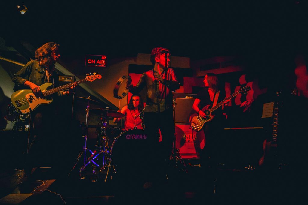 Greta Van Fleet live concert red lighting intense performance classic rock band wallpaper
