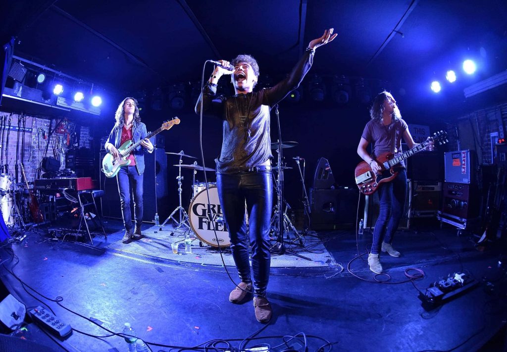 Greta Van Fleet live performance with Josh Kiszka singing and band in blue concert lighting wallpaper