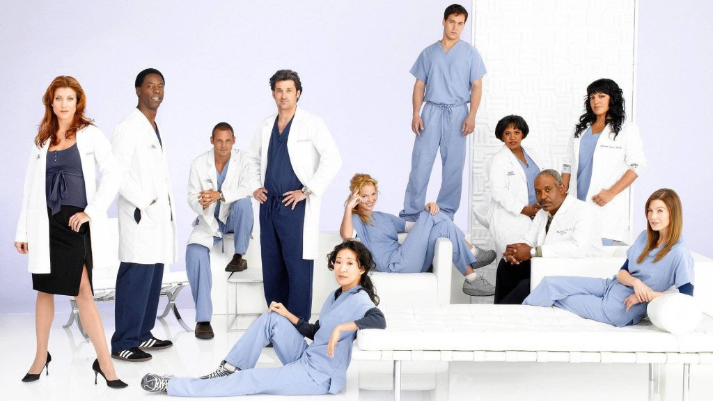 Grey's Anatomy cast Ellen Pompeo Patrick Dempsey Sandra Oh in medical scrubs bright studio Wallpaper