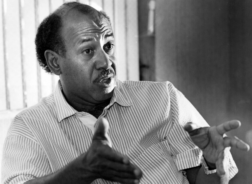 Greyscale portrait of Alcee Hastings in thoughtful conversation American politician wallpaper background