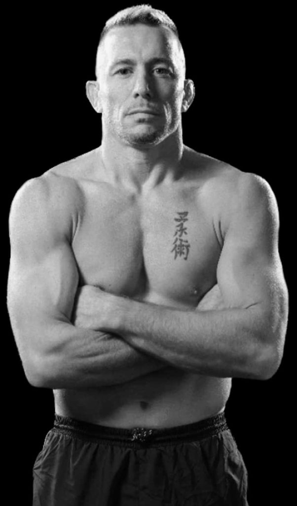 Greyscale portrait of MMA legend Georges St-Pierre with tattoo and intense expression background Wallpaper